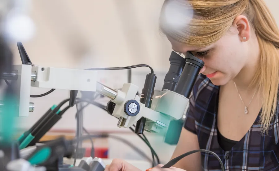 undergraduate mechatronic looking through a telescope