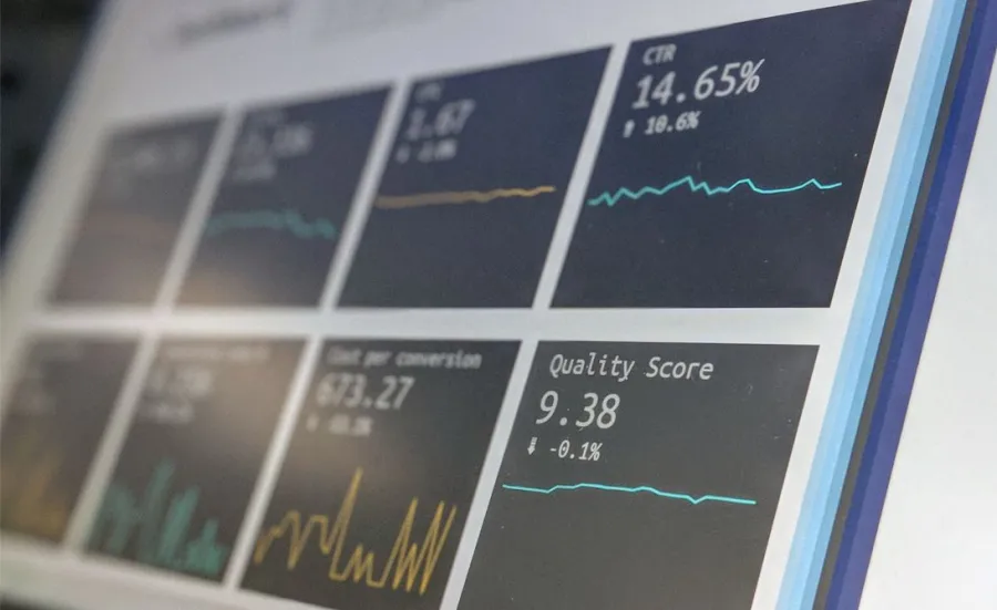 Business analytics visible in foreground of angled computer screen