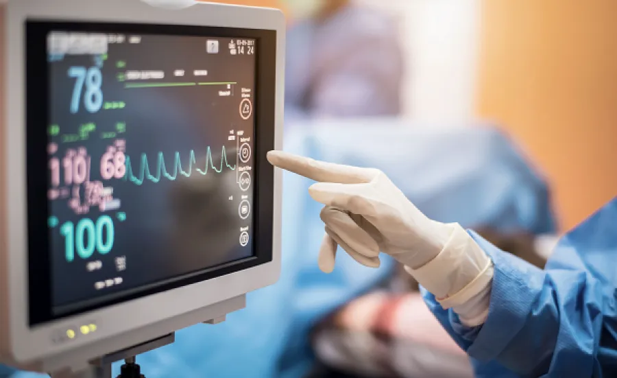 A surgeon monitoring a screen.