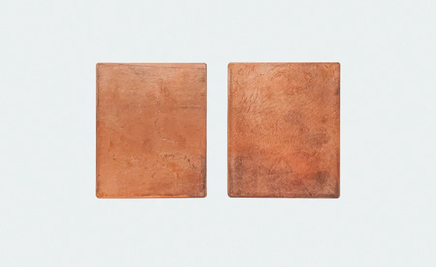 Two rectangle shapes made of copper placed on a white background