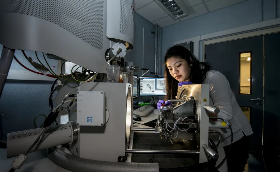 A student working in a workshop, at a desk.