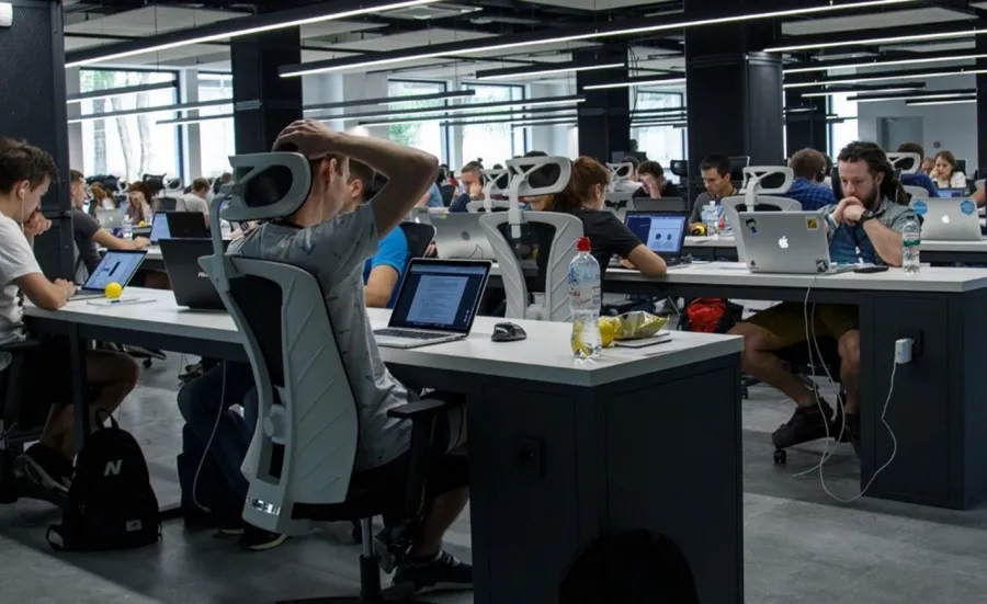 Workers in a digital technology company working in an open-plan office space