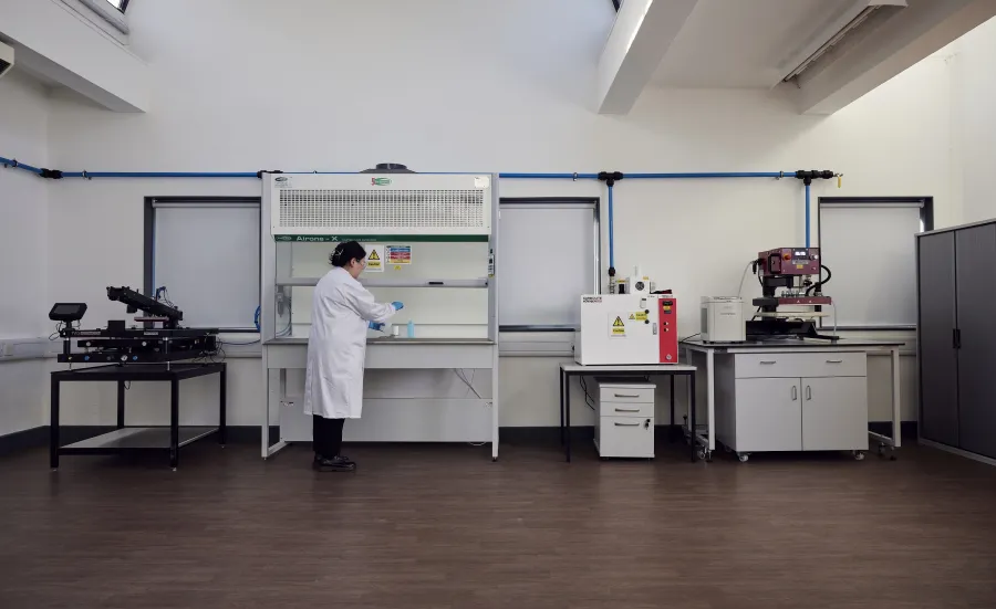 A woman researcher working at the e-textile laboratory