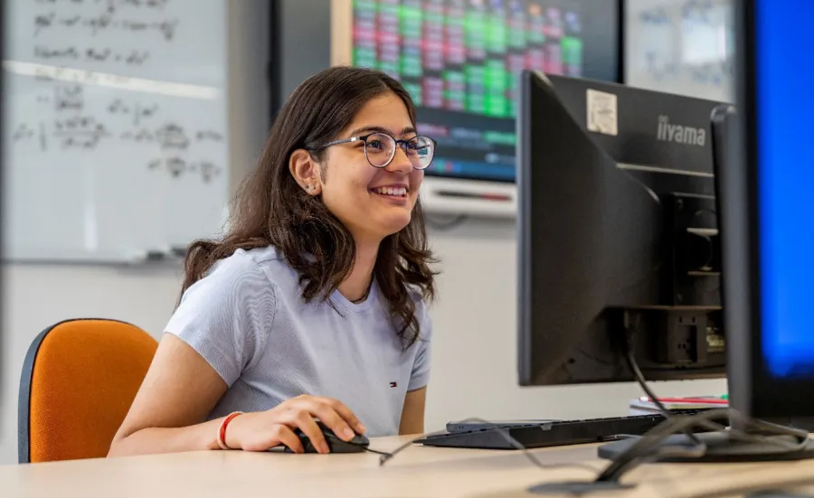 Navya Gulati working at a computer station