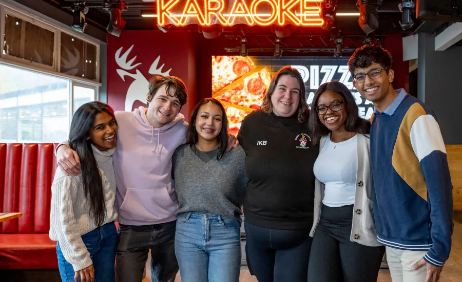 Group of smiling students in bar