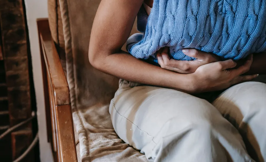 A woman with her hands on her stomach