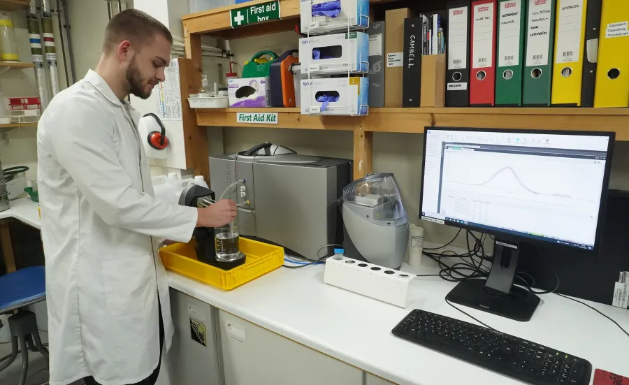 Researcher examining  flow over seagrass mimics in the lab