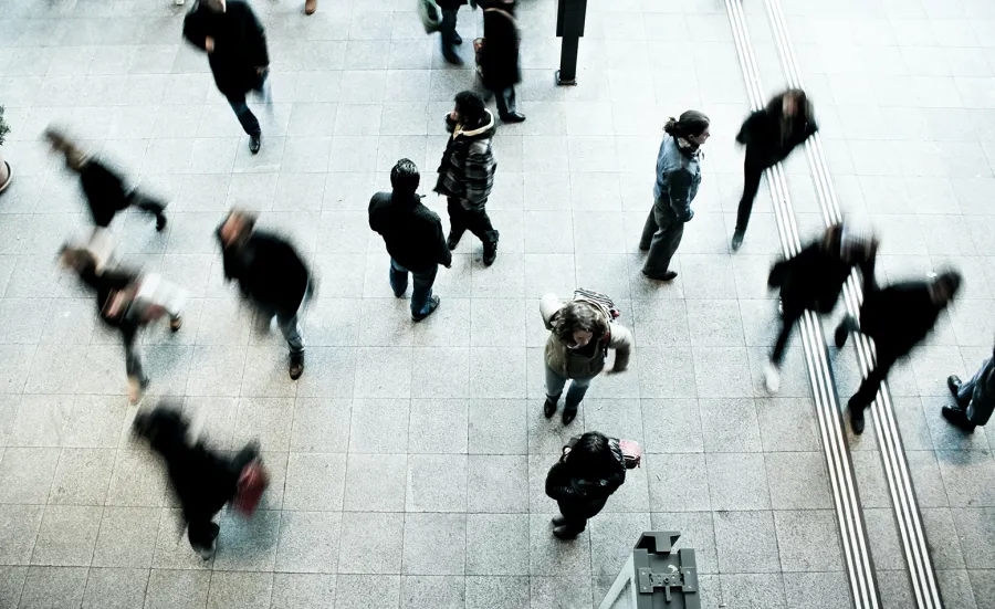 People walking along a busy city street, pictured from above