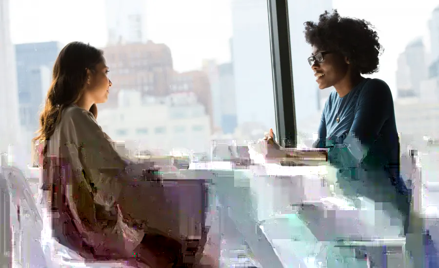 Two women talking at a table