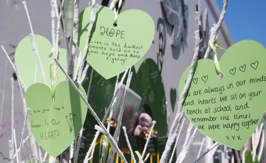 Green paper hearts with mesaages of rememberance for Grenfell Tower victims hearts with 