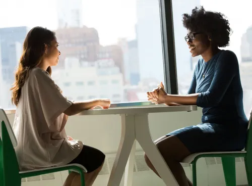 Two women talking at a table