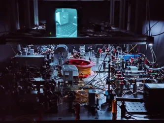 An optical table with components such as lasers, tapered amplifiers, optical fibers and various free-space optics and optomechanics. 