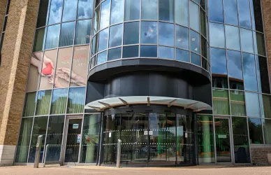 Exterior view of the modern glass-fronted building that houses the Institute of Developmental Sciences.