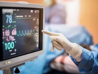 A surgeon monitoring a screen.