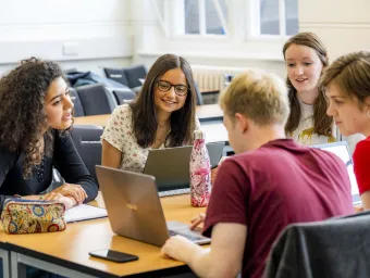 Modern Language students discussing laptop contents