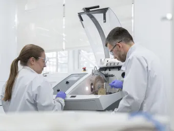 Researchers using equipment in a laboratory