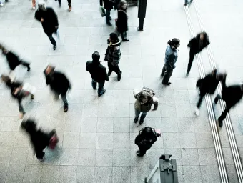 People walking along a busy city street, pictured from above