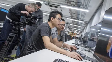 Two students working at a computer in the David Barron computing lab.