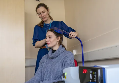 A person using neurostimulation lab equipment