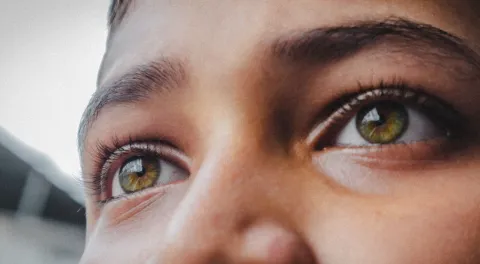 Close up of a young person's eyes looking into the distance