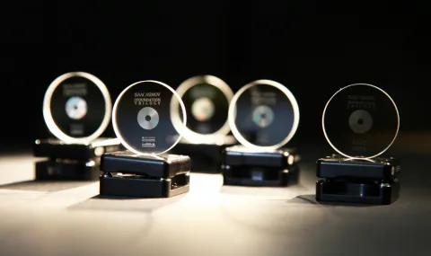 A row of 5 memory crystals on stands, softly lit against a black background. They have been imprinted with copies of the Foundation trilogy by Isaac Asimov.