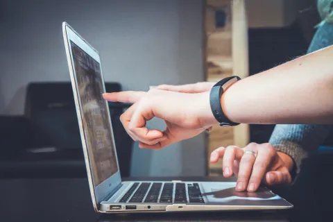 Two people looking at a laptop