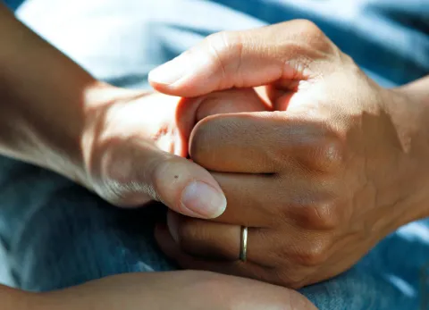 Unsplash image of a couple's clasped hands