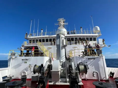 crew waving on the bridge of a research vessel