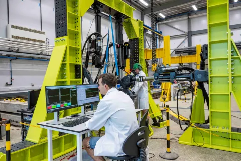 2 researchers with large scale testing equipment