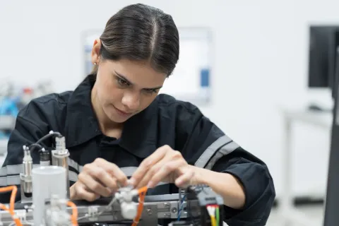 A woman fixing an electronic device