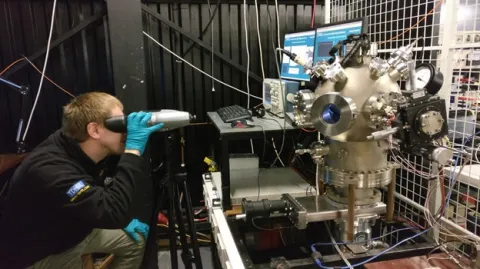 A man using binoculars during an experiment of electrical power