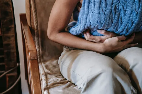 A woman with her hands on her stomach