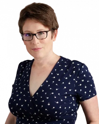 Portrait photograph of Professor Lucy Green, she is wearing black-framed glasses and a blue dress with small white spots. The background has been removed.