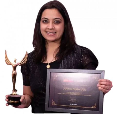 A woman dressed in black smiles while holding a gold trophy in one hand and a framed certificate in the other, which displays her achievement. The background is transparent.