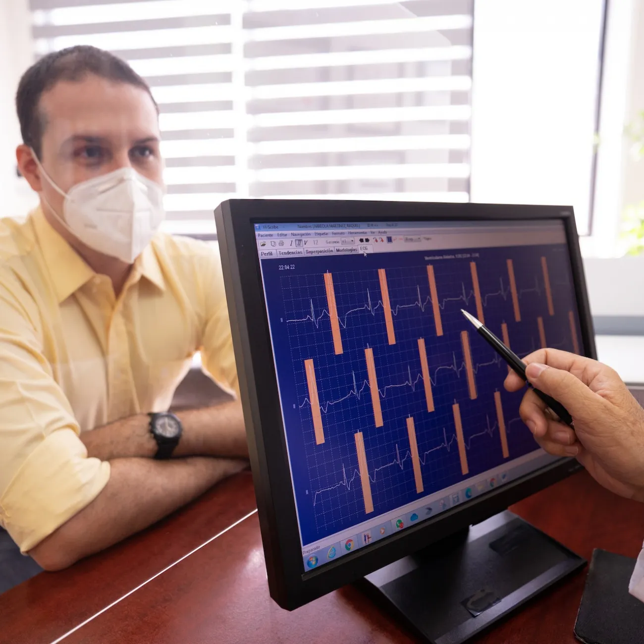 A patient and doctor discuss data on heart activity from an ECG or electrocardiogram