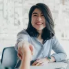 Women shaking hands over a desk