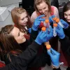 A group of school pupils in a lab examining liquid samples