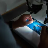 Person working on a circuit board