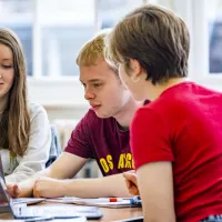 Modern Language students discussing laptop contents