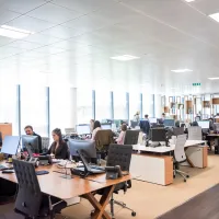 Image showing people working in a large office space.