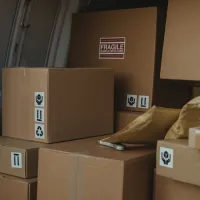 Pexels image of brown parcels stacked inside a delivery van