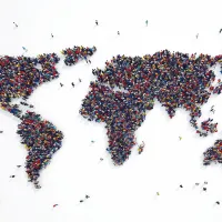 A crowd of people photographed from above, making up a map of the world