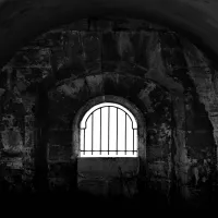 Dark prison cell with barred window