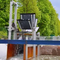 A modern water wheel on a small river