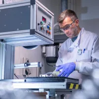 Scientist carrying out experiment using the facilities equipment